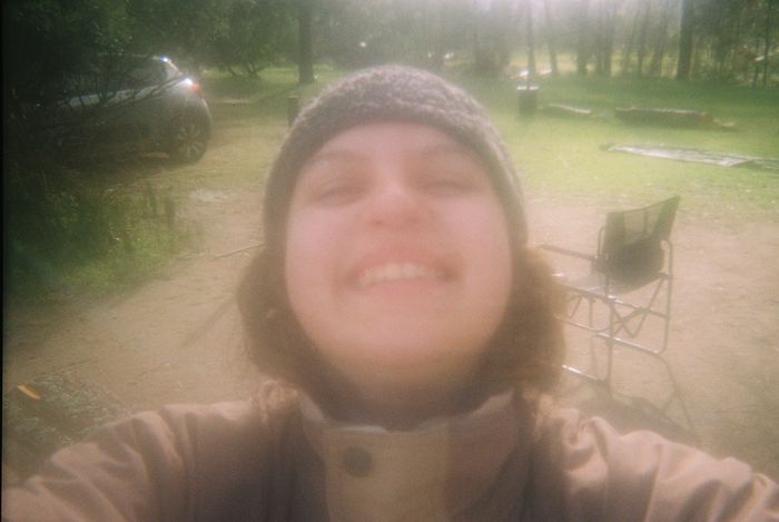 Anneme smiling in a selfie taken on a film camera
